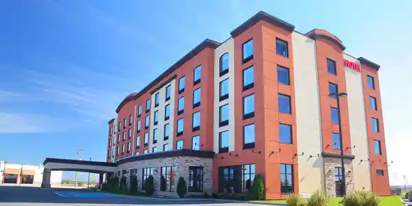 qt=q_24 A large hotel with many windows and a building